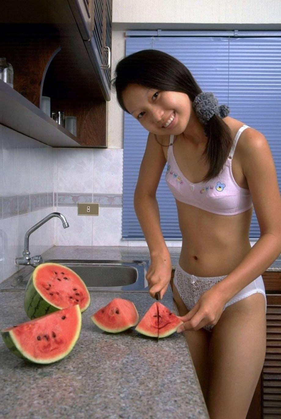 Charming Asian teen removes lace underwear while eating a watermelon